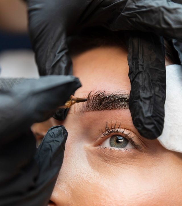 young-woman-getting-beauty-treatment-her-eyebrows